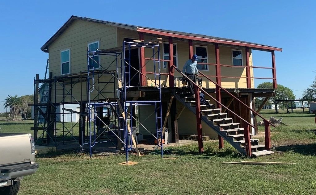 Raised-home re-roofing and exterior renovation in progress by Skystone Homes LLC